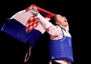 <p>Team Croatia's Matea Jelic waves the Croatian flag after defeating Lauren Williams of Team Great Britain at Women's -67kg taekwondo at Makuhari Messe Hall on July 26.</p>