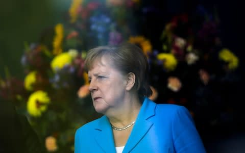 German Chancellor Angela Merkel waits for the arrival of Irish President Michael D. Higgins for meeting at the chancellery in Berlin, Wednesday, July 3, 2019. - Credit: Markus Schreiber/AP