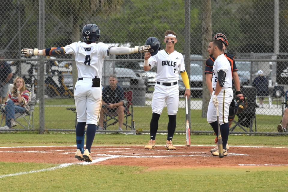 West Boca's Alan Hernandez is greeted by Tyler Lichtenberger at the plate after his home-run during a regular season game against Benjamin on April 11, 2024.