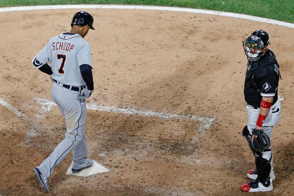 Detroit Tigers' Jonathan Schoop, left, crosses home plate after hitting a solo home run off Chicago White Sox starting pitcher Dallas Keuchel (not shown) during the sixth inning at Guaranteed Rate Field in Chicago on Friday, June 4, 2021.