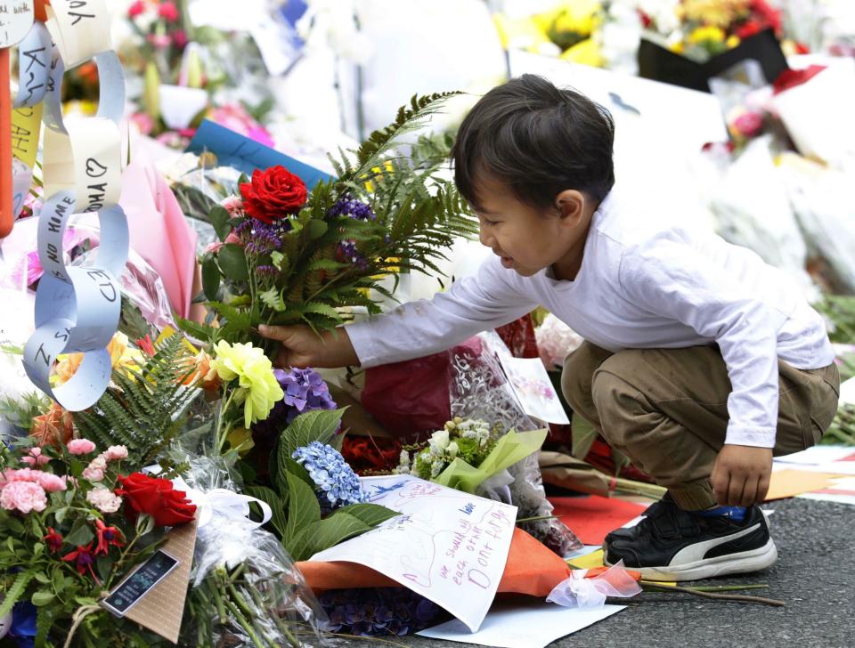 A child offers flowers near the Al Noor mosque in Christchurch on March 19. Source: AAP