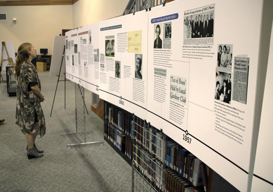 Cheyenne Anderson looks over some of the work that she and fellow researchers from The Ohio State University at Marion did for a project on the history of literacy initiatives conducted in Marion. An exhibit highlighting their research was unveiled Sept. 21, 2023.