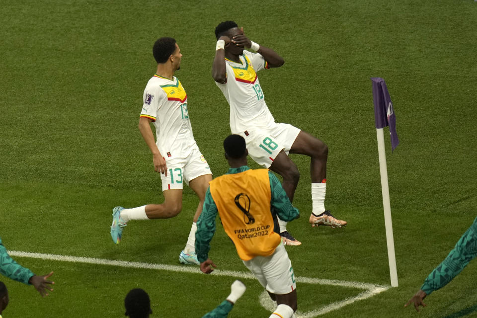 Senegal's Famara Diedhiou, right, celebrates after scoring his side's first goal during the World Cup group A soccer match between Ecuador and Senegal, at the Khalifa International Stadium in Doha, Qatar, Tuesday, Nov. 29, 2022. (AP Photo/Aijaz Rahi)