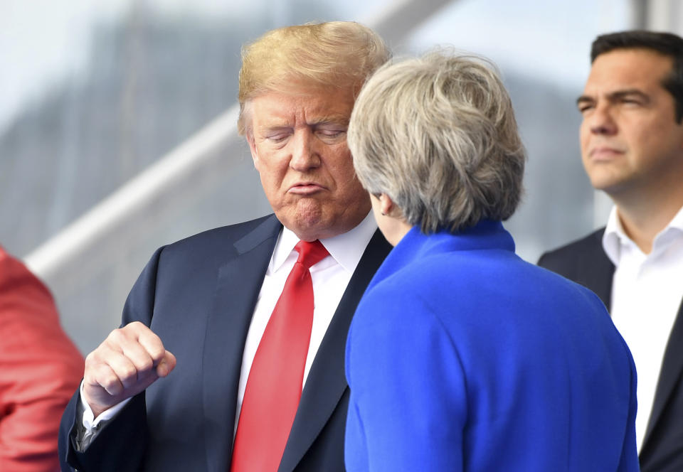 <p>President Trump clenches a fist when talking to British Prime Minister Theresa May during a summit of heads of state at NATO headquarters in Brussels on Wednesday, July 11, 2018. NATO leaders gathered in Brussels for a two-day summit to discuss Russia, Iraq and their mission in Afghanistan. (Photo: Geert Vanden Wijngaert/AP) </p>