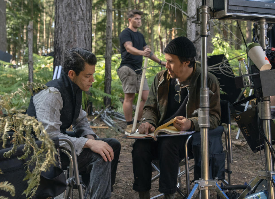 This mage released by MGM shows director Cary Joji Fukunaga, right, with actor Rami Malek on the set of the James Bond film "No Time to Die." (Nicola Dove/MGM via AP)