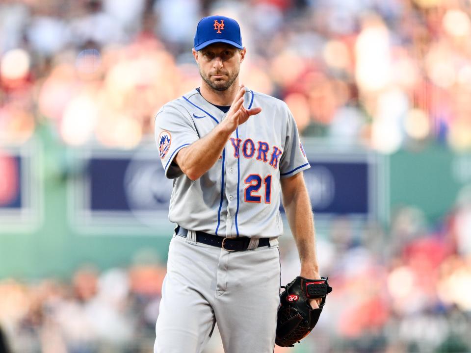 New York Mets starting pitcher Max Scherzer (21) signals before pitching in the first inning of a game against the Boston Red Sox on July 22, 2023, at Fenway Park.