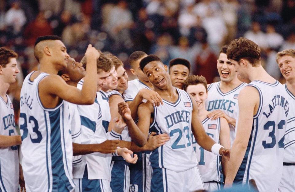 Duke’s Brian Davis (23) leads the Blue Devils in celebration at the trophy presentation after winning their first-ever NCAA Final Four championship in Indianapolis Monday, April 2, 1991. Duke defeated Kansas 72-65. At far left is Grant Hill (33), Christian Laettner (32) is at far right.