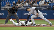 Umpire Ramon De Jesus (18) watches as Tampa Bay Rays' Randy Arozarena beats the tag from New York Yankees first baseman Anthony Rizzo on a pickoff throw during the first inning of a baseball game Friday, May 10, 2024, in St. Petersburg, Fla. (AP Photo/Steve Nesius)