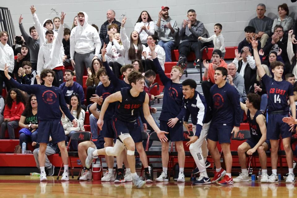 Central Bucks East junior Jake Cummiskey celebrates with teammates after hitting a 3-pointer in the Patriots' PIAA first-round state playoff loss to Archbishop Wood.