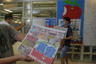 Reporters of Apple Daily take photo at the headquarters in Hong Kong, Thursday, June 24, 2021. Hong Kong's pro-democracy Apple Daily newspaper will stop publishing Thursday, following last week's arrest of five editors and executives and the freezing of $2.3 million in assets under the city's year-old national security law. (AP Photo/Kin Cheung)