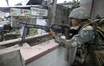 Government soldiers take positions at a military checkpoint in downtown Zamboanga September 11, 2013. (REUTERS/Erik De Castro)