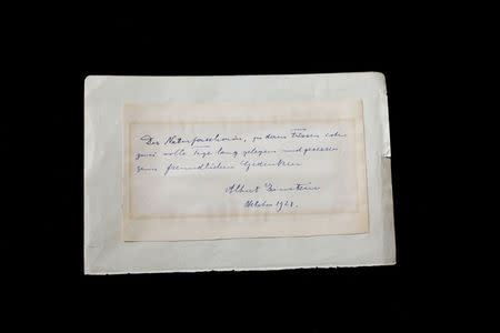 A note written by Albert Einstein to Italian chemistry student Elisabetta Piccini in Florence, Italy, in 1921 is seen before it is sold at an auction in Jerusalem, March 6, 2018. REUTERS/Ronen Zvulun