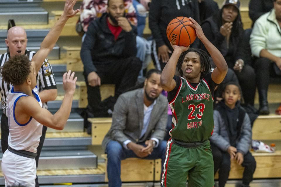 Lawrence North High School junior Azavier Robinson (23) shoots during the second half of a Boysâ€™ Marion County Basketball Tournament championship game against Franklin Central High School, Saturday, Jan. 13, 2024, at Southport High School. Lawrence North won, 78-53.