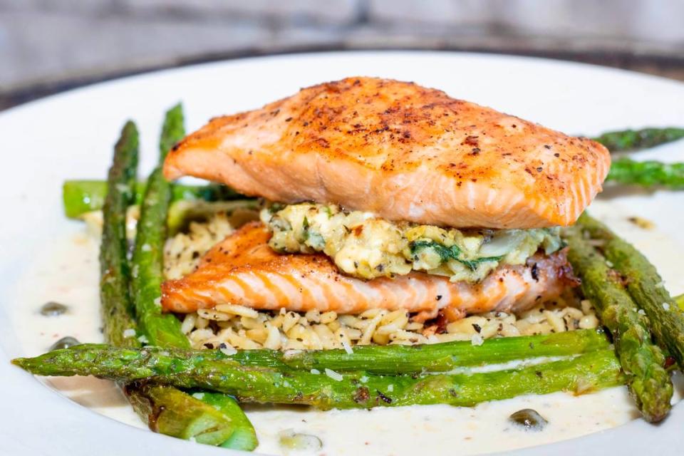 Salmon stuffed with crab and artichoke, served with spinach and asparagus at Rockfish Seafood Grill.