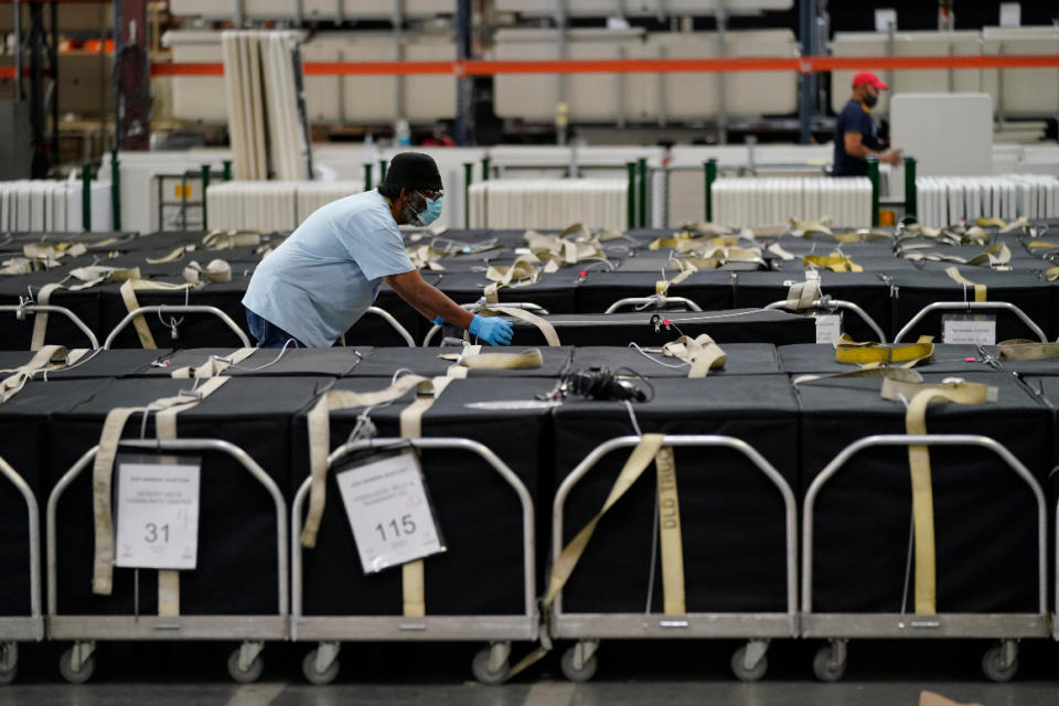 On Nov. 4, a county election worker moves voting machines at the Clark County Election Department in Las Vegas. 