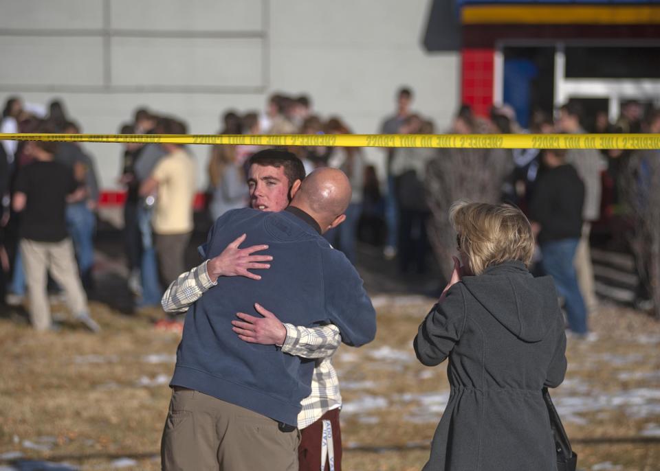 Students gather and reunite with their families at a fast food joint across from Arapahoe High School, after a student opened fire in the school in Centennial, Colorado December 13, 2013. The student seeking to confront one of his teachers opened fire at the Colorado high school on Friday, wounding at least two classmates before apparently taking his own life, law enforcement officials said. REUTERS/Evan Semon (UNITED STATES - Tags: EDUCATION CRIME LAW)