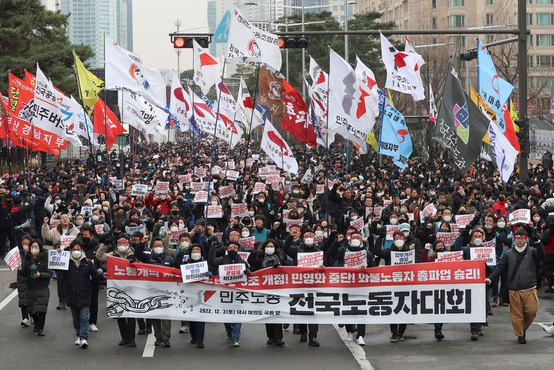 South Korean workers from the country's biggest labour union march during a rally in Seoul