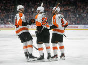 Philadelphia Flyers' Sean Couturier (14), Claude Giroux (28) and Ivan Provorov (9) celebrate a goal against the Edmonton Oilers during the first period of an NHL hockey game, Wednesday, Oct. 27, 2021 in Edmonton, Alberta. (Jason Franson/The Canadian Press via AP)