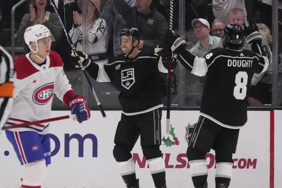Los Angeles Kings center Trevor Lewis, center, celebrates after scoring during the third period of an NHL hockey game against the Montreal Canadiens, Saturday, Nov. 25, 2023, in Los Angeles. (AP Photo/Marcio Jose Sanchez)
