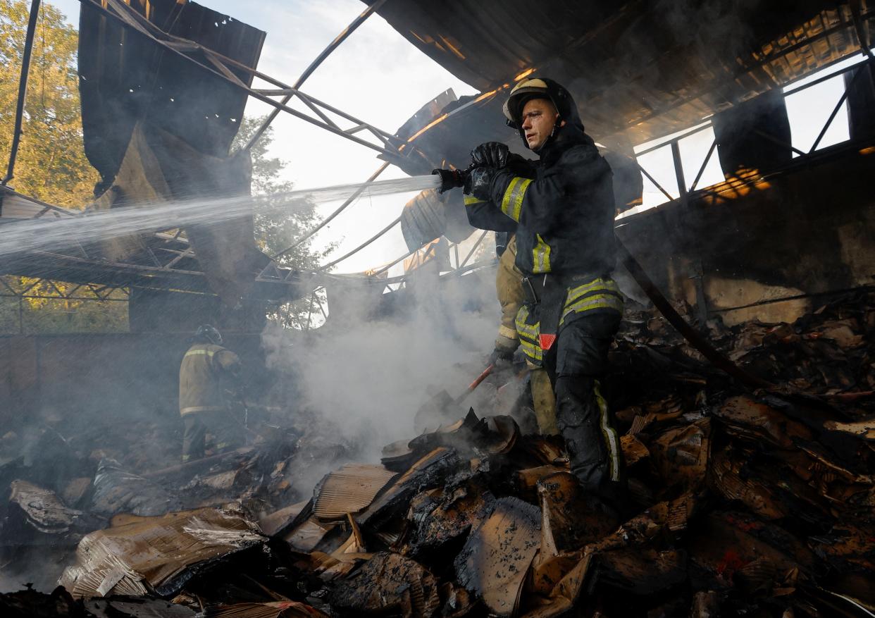 Firefighters work to extinguish fire at a warehouse destroyed in shelling in the course of Russia-Ukraine conflict in Donetsk (REUTERS)