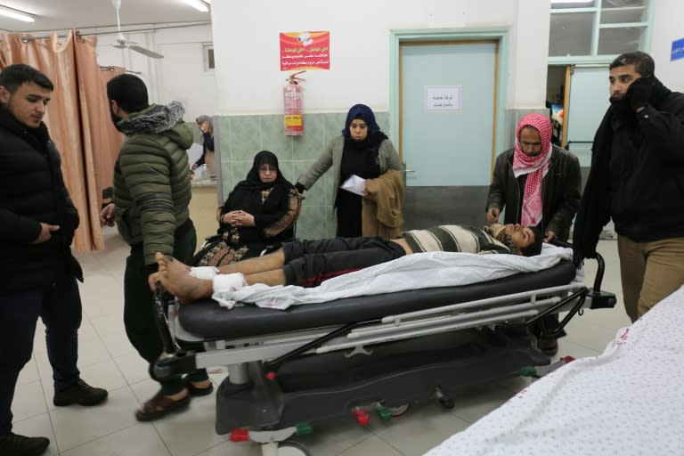 An injured Palestinian man arrives at a hospital to receive treatment following an Israeli air strike in the southern Gaza Strip