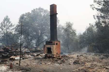 A chimney stands amidst remains of a home destroyed by the Detwiler fire in Mariposa, California. REUTERS/Stephen Lam