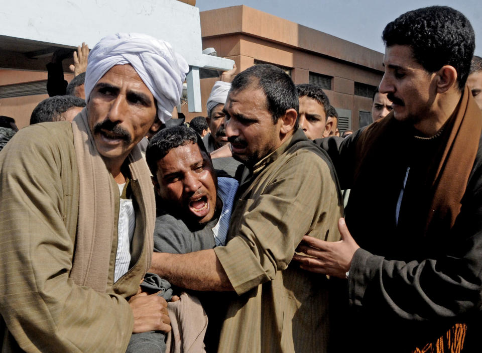 The brother of a policeman mourns during the funeral of one of several policemen killed after masked gunmen opened fire at a police checkpoint in el-Wassta district in the province of Bani Suief, south of the Egyptian capital, Cairo, Egypt, Thursday, Jan. 23, 2014. Masked gunmen riding on motorcycles opened fire at a police checkpoint in central Egypt early on Thursday, killing several policemen and wounding two, the Interior Ministry said. (AP Photo/Mohammed Asad)