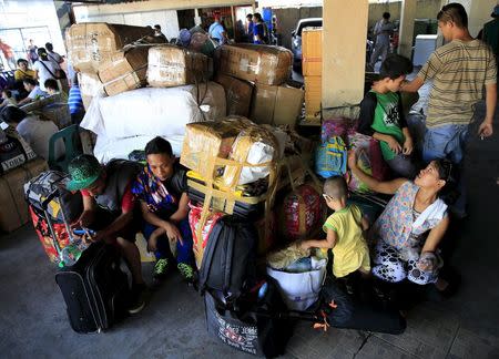 Stranded passengers guard their belongings while waiting at a bus terminal in Manila May 9, 2015. REUTERS/Romeo Ranoco - RTX1C6YO