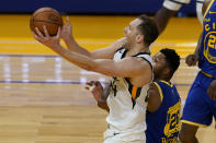 Utah Jazz forward Bojan Bogdanovic, left, shoots against Golden State Warriors forward Kent Bazemore during the first half of an NBA basketball game in San Francisco, Monday, May 10, 2021. (AP Photo/Jeff Chiu)