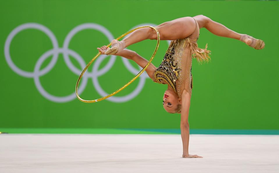 <p>Yana Kudryavtseva of Russia performs during the Rhythmic Gymnastics Individual All-Around on August 20, 2016 at Rio Olympic Arena in Rio de Janeiro, Brazil. (Get </p>