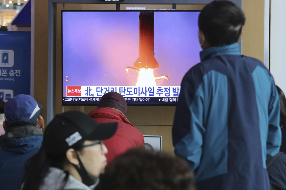 People watches a television screen showing a file image of North Korea's missile launch during a news program at the Seoul Railway Station in Seoul, South Korea, Saturday, March 21, 2020. North Korea on Saturday fired two presumed short-range ballistic missiles into the sea, South Korea's military said, as it continues to expand military capabilities amid deadlocked nuclear negotiations with the Trump administration and a crippling global health crisis. (AP Photo/Ahn Young-joon)