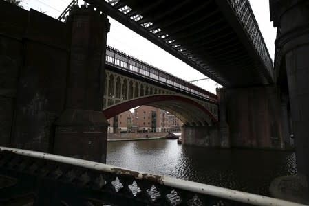 Trainlines run over a canal in central Manchester, northern England