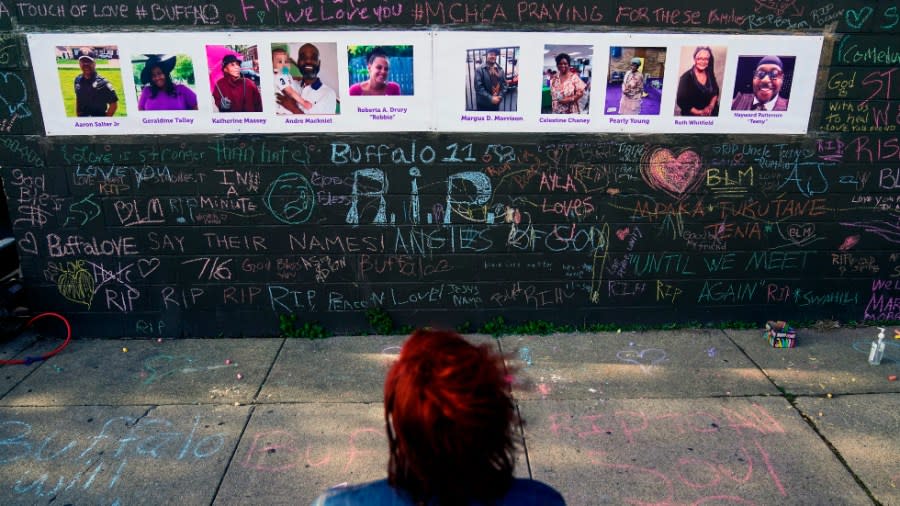 A person visits a makeshift memorial near the scene of the mass shooting at a supermarket in Buffalo, N.Y. (Matt Rourke/AP Photo)