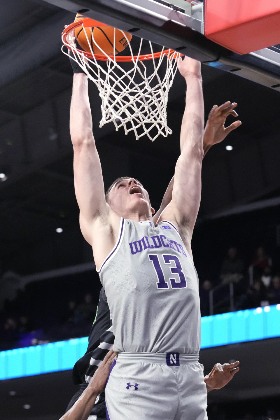 Northwestern guard Brooks Barnhizer (13) goes up for a shot past Chicago State forward Cameron Jernigan during the first half of an NCAA college basketball game in Evanston, Ill., Wednesday, Dec. 13, 2023. (AP Photo/Nam Y. Huh)