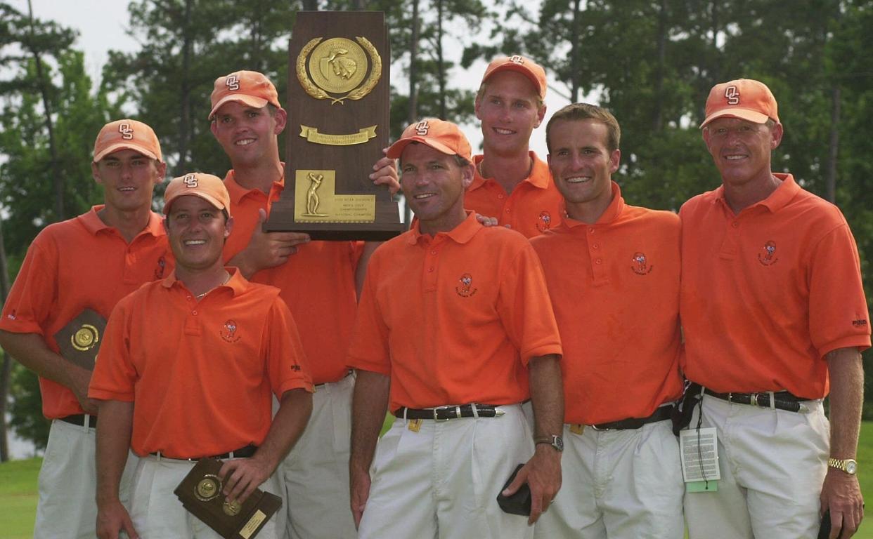 The OSU men's golf team poses with the NCAA men's golf championship trophy after beating Georgia Tech in a one-hole playoff on June 3, 2000, in Opelika, Ala. Pictured, from left are: Charles Howell, Landry Mahan, Edward Loar, assistant coach Mike McGraw, Anders Hultman, J.C. DeLeon and coach Mike Holder.