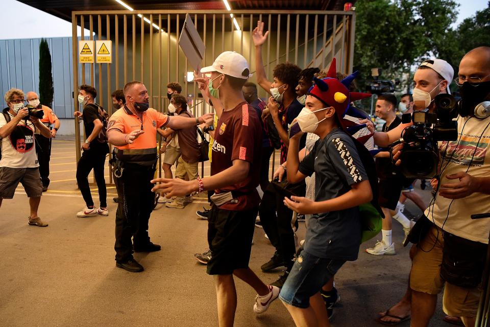 FC Barcelona fans walk into the Camp Nou stadium premises in Barcelona on August 26, 2020 after Barcelona's Argentinian forward Lionel Messi announced his desire to leave the club. - Lionel Messi's bombshell request to leave Barcelona is expected to spark a legal battle over a multi-million-dollar buy-out clause but also raises the question of which club could afford him in the heat of the coronavirus pandemic. (Photo by Pau BARRENA / AFP) (Photo by PAU BARRENA/AFP via Getty Images)