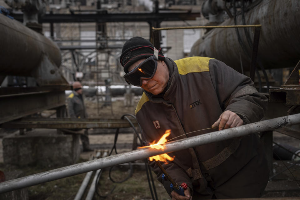 A worker in a power plant, repairs damages after a Russian attack in central Ukraine, Thursday, Jan. 5, 2023. When Ukraine was at peace, its energy workers were largely unheralded. War made them heroes. They're proving to be Ukraine's line of defense against repeated Russian missile and drone strikes targeting the energy grid and inflicting the misery of blackouts in winter. (AP Photo/Evgeniy Maloletka)