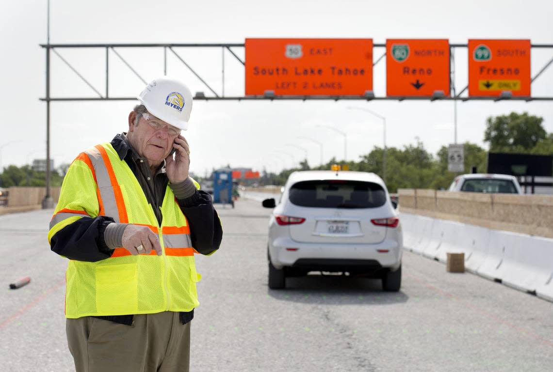 C.C. Myers talks on his phone atop the W-X freeway in Sacramento while construction crews prepared to repave its surface as part of the Fix50 project in 2014. The legendary Sacramento construction icon, who gained fame rebuilding damaged California freeways at breakneck speed, died Wednesday at the age of 85. Randy Pench/Sacramento Bee file