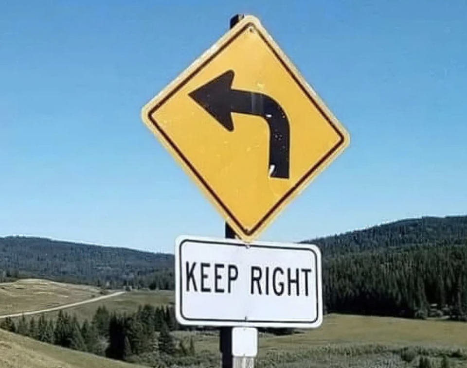 Traffic sign with a left arrow above a "KEEP RIGHT" sign, creating a contradictory message
