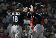 Chicago White Sox's AJ Pollock (18) congratulates Luis Robert after scoring on Robert's two-run home run during the third inning of the team's baseball game against the Boston Red Sox at Fenway Park, Friday, May 6, 2022, in Boston. (AP Photo/Mary Schwalm)