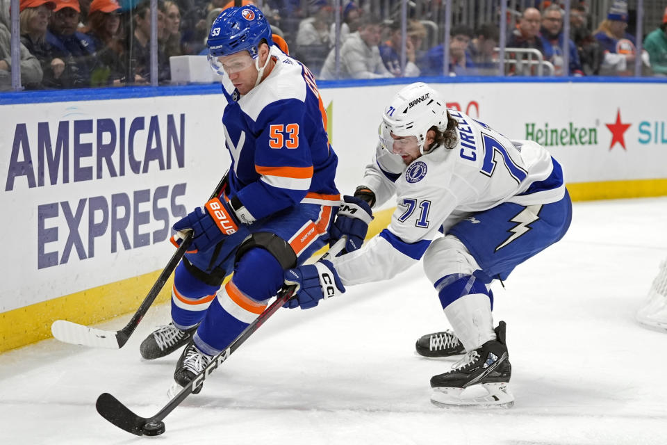 Tampa Bay Lightning's Anthony Cirelli (71) fights for control of the puck with New York Islanders' Casey Cizikas (53) during the second period of an NHL hockey game Saturday, Feb. 24, 2024, in Elmont, N.Y. (AP Photo/Frank Franklin II)