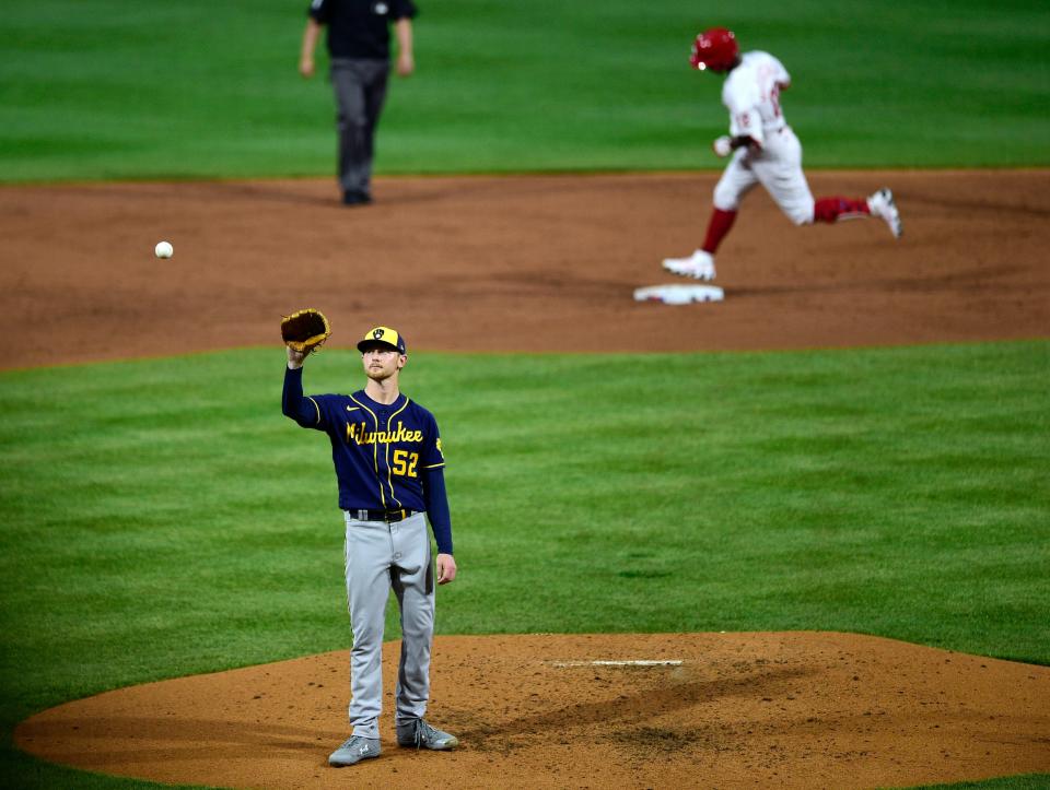 Milwaukee Brewers starting pitcher Eric Lauer receives a new ball after giving up a home run to Philadelphia Phillies' Andrew McCutchen during the third inning of a baseball game, Tuesday, May 4, 2021, in Philadelphia