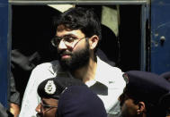 FILE - In this March 29, 2002 file photo, Ahmed Omar Saeed Sheikh, a British-Pakistani man accused in the 2002 killing of the American Wall Street Journal reporter Daniel Pearl appears at the court in Karachi, Pakistan. In a dramatic turn of events, Sheikh, a man convicted and later acquitted in the 2002 murder of Pearl admitted a "minor" role in his death, upending 18 years of denials, the Pearl family lawyer said Wednesday, Jan. 27, 2021. (AP Photo/Zia Mazhar, File)