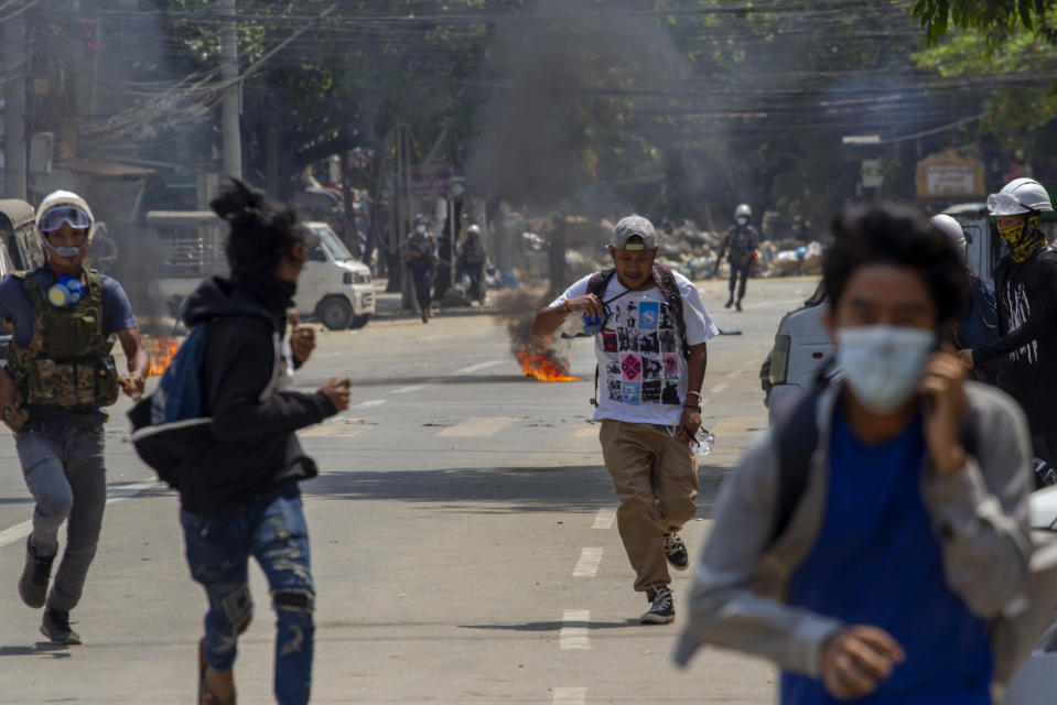 Anti-coup protesters abandon their makeshift barricade and run as armed riot policemen charge in Yangon, Myanmar Tuesday, March 16, 2021. Demonstrators in several areas of Myanmar protesting last month’s seizure of power by the military held small, peaceful marches before dawn Tuesday, avoiding confrontations with security forces who have shot dead scores of their countrymen in the past few days. (AP Photo)