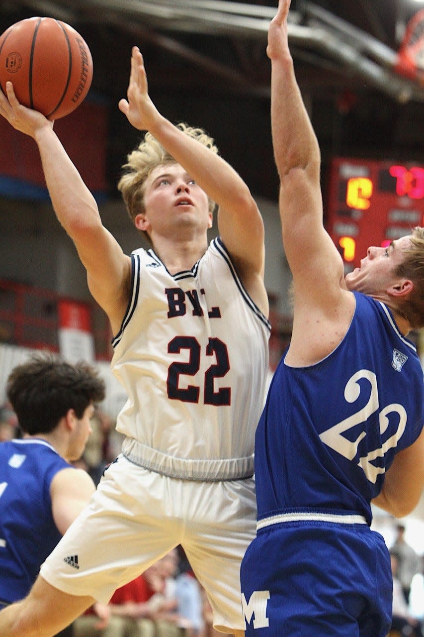 BNL guard Colton Staggs elevates over Evansville Memorial's Connor Agler to score two of his game-high 20 points Saturday afternoon at BNL Fieldhouse.