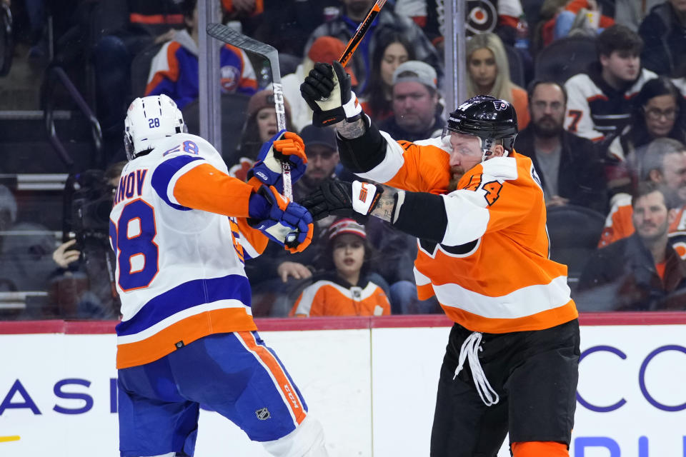Philadelphia Flyers' Nicolas Deslauriers, right, and New York Islanders' Alexander Romanov collide during the second period of an NHL hockey game, Monday, Feb. 6, 2023, in Philadelphia. (AP Photo/Matt Slocum)