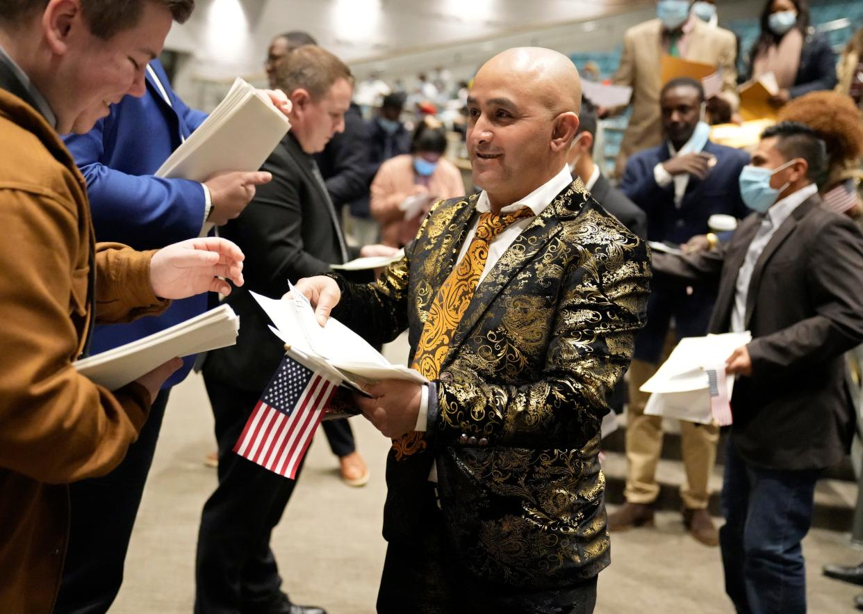 Wearing a suit that stood out, Chandra Chhetri, of Bhutan, at a naturalization ceremony on Thursday, Nov. 17, 2022 at Worthington Kilbourne High School.