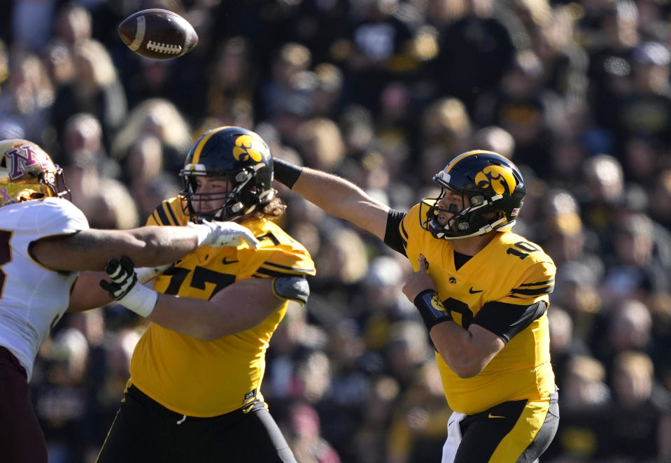 Iowa quarterback Deacon Hill (10) sends a pass downfield during the first half of an NCAA college football game against Minnesota, Saturday, Oct. 21, 2023, in Iowa City, Iowa. (AP Photo/Matthew Putney)