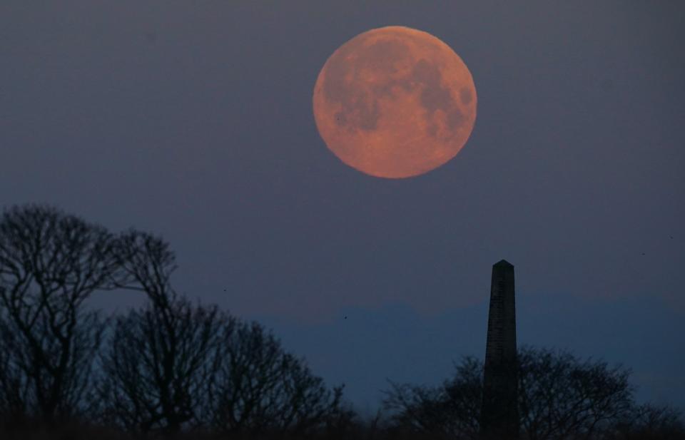 The full moon known as the 'Snow moon' sets over Whitley Bay in North Tyneside (Owen Humphreys/PA Wire)