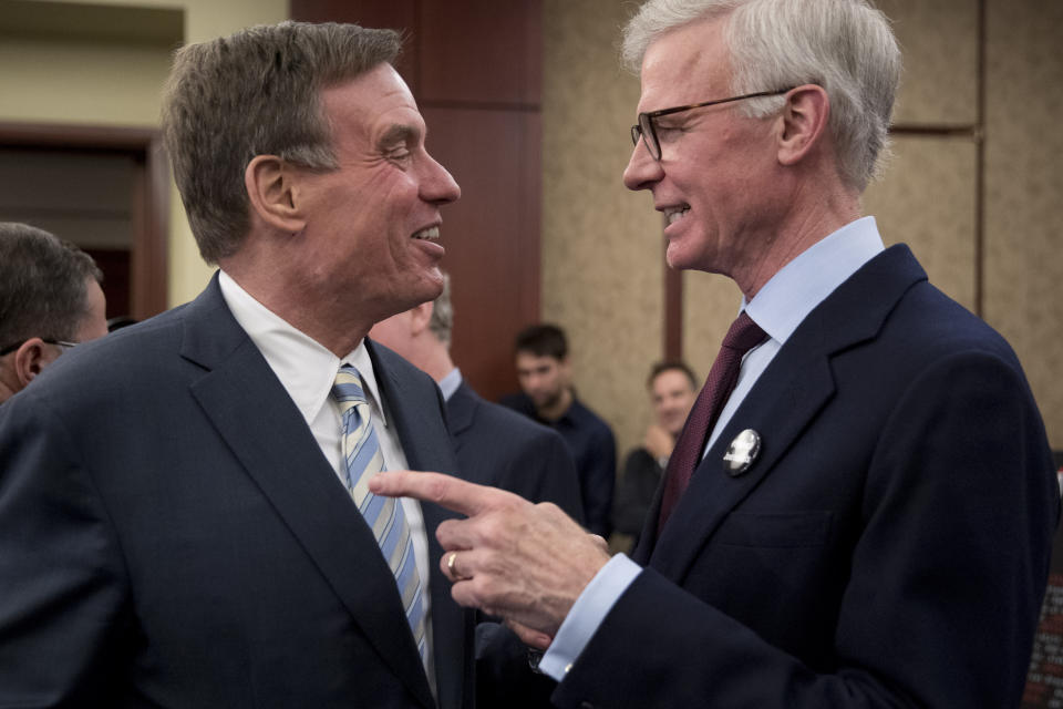 Sen. Mark Warner, D-Va., left, speaks with Washington Post Publisher Fred Ryan, right, at an event marking 100 days since the death of Jamal Khashoggi on Capitol Hill in Washington, Thursday, Jan. 10, 2019. Amnesty International on Thursday renewed a call for an international investigation into the killing of Washington Post columnist Jamal Khashoggi. (AP Photo/Andrew Harnik)